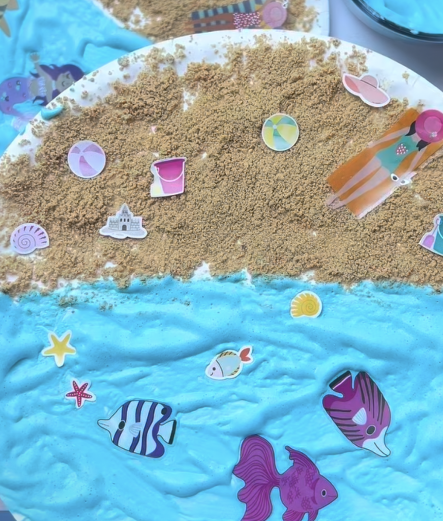 Paper plate beach craft with sand and colorful seaside decorations