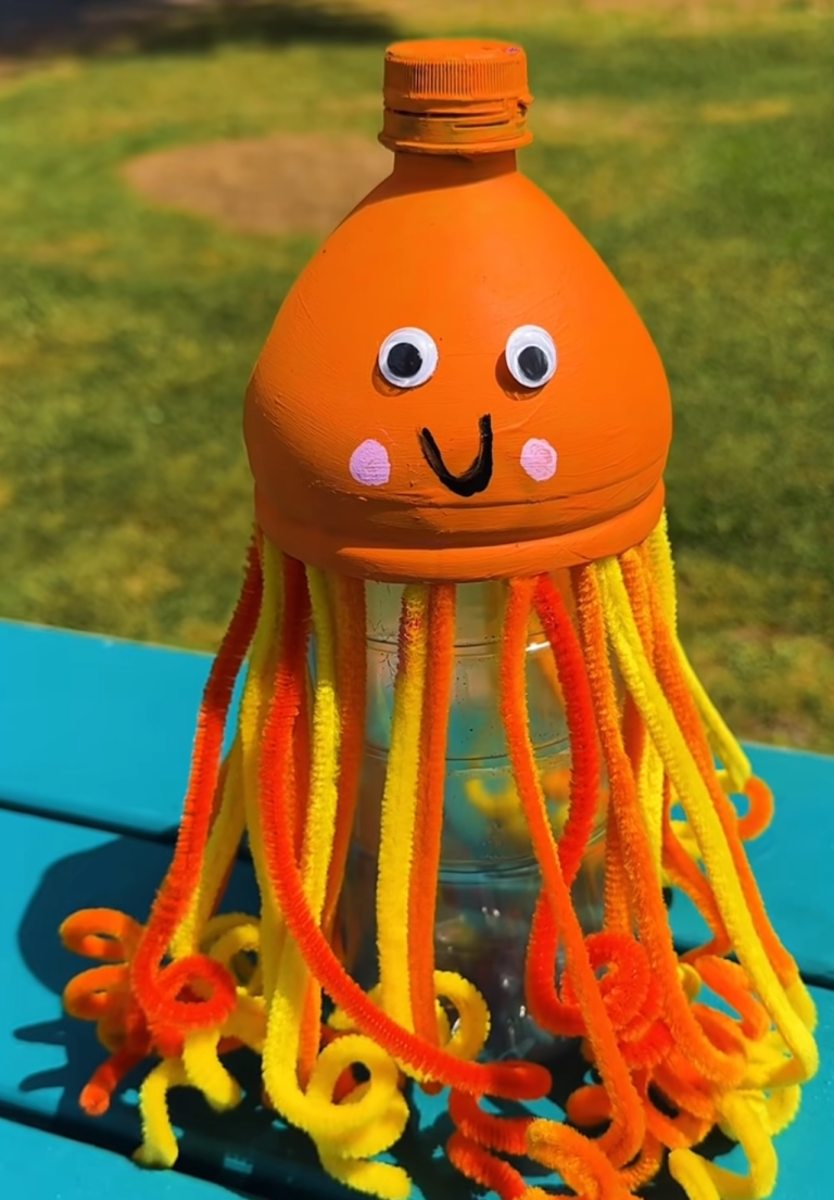 Orange bottle octopus craft with colorful yarn tentacles